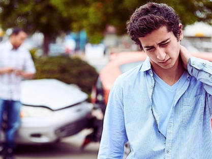 Teenage Driver Suffering Whiplash Injury Traffic Accident Rubbing Neck With Hand.