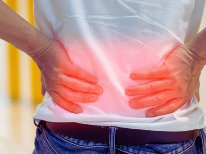 Man's hands on his back with red spot as suffering on backache.