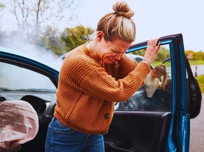 Female Motorist In Crash For Crash Insurance Fraud Getting Out Of Car.
