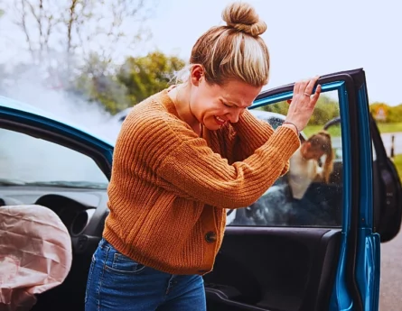 Female Motorist In Crash For Crash Insurance Fraud Getting Out Of Car.