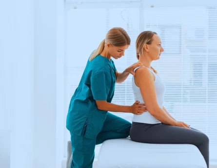 A professional doctor and a woman patient having her Chiropractic session.