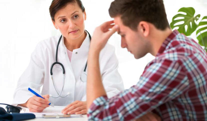 Red Flags Chiropractors Should Watch for When Treating Accident Victims 1 man with headache talking to doctor