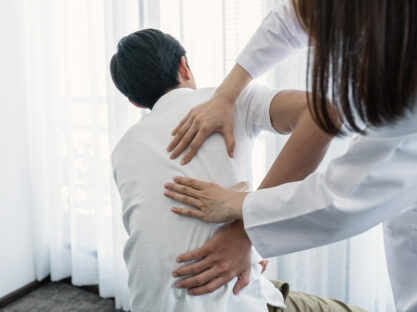 female doctor treating patient's back