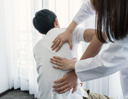 female doctor treating patient's back