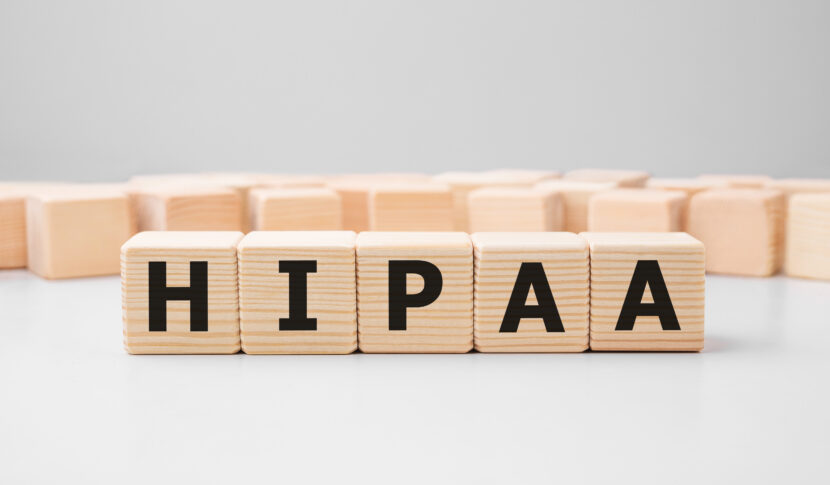 What Should Chiropractors Know About HIPAA When Working With Lawyers? 1 Wooden blocks arranged to spell out "HIPAA" in black letters.