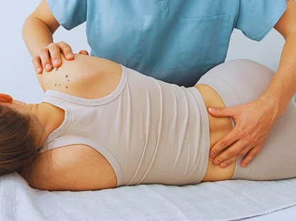 a nurse or healthcare professional providing care to a patient lying on their side.