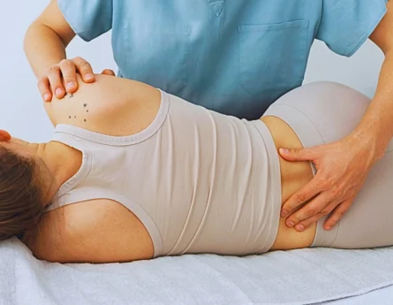 a nurse or healthcare professional providing care to a patient lying on their side.